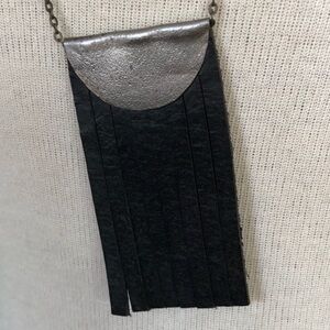 Black leather and silver long necklace.